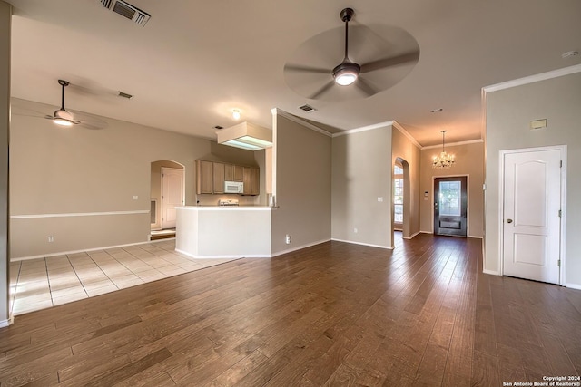 unfurnished living room with light wood-type flooring, ornamental molding, and ceiling fan with notable chandelier