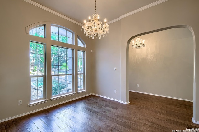 interior space featuring dark wood-type flooring, a wealth of natural light, ornamental molding, and an inviting chandelier