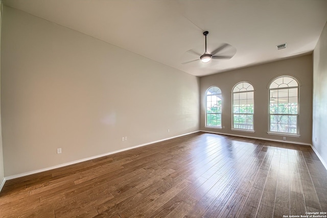 unfurnished room featuring ceiling fan and dark wood-type flooring