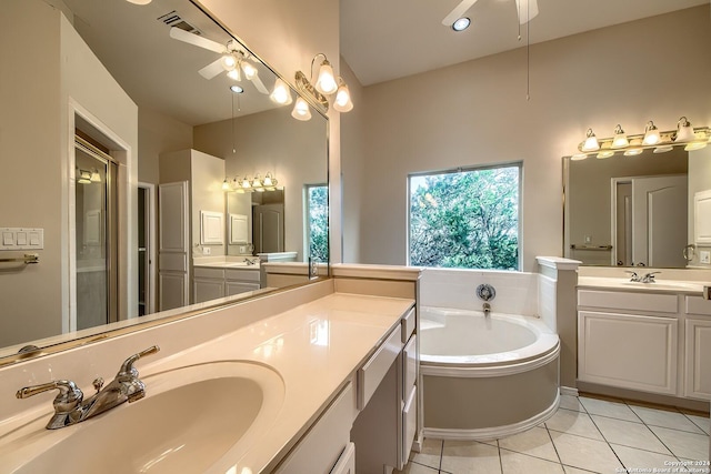 bathroom featuring ceiling fan, a bathing tub, tile patterned floors, a towering ceiling, and vanity