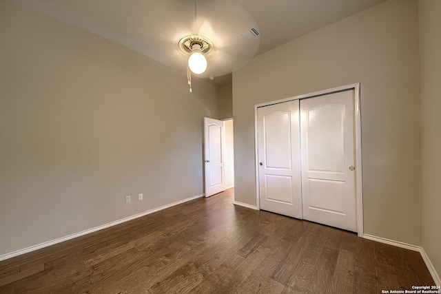 unfurnished bedroom featuring a closet and dark hardwood / wood-style flooring