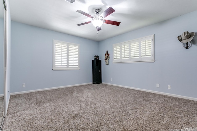 spare room featuring ceiling fan and carpet flooring