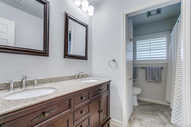 bathroom featuring toilet and vanity