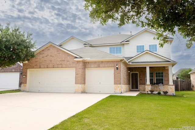 view of front facade with a front yard, a porch, and a garage