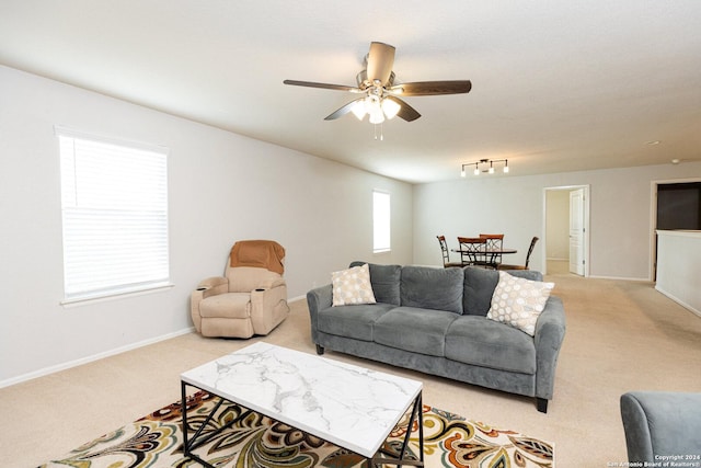 living room featuring ceiling fan, rail lighting, and light carpet