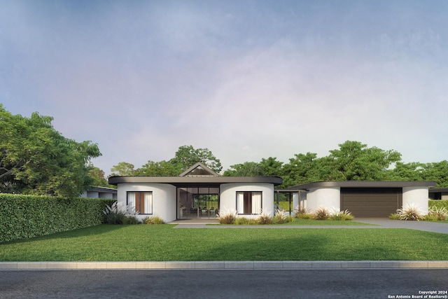 view of front facade featuring a garage, concrete driveway, a front lawn, and stucco siding