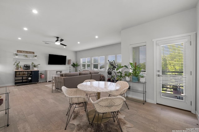 dining area featuring light hardwood / wood-style floors, ceiling fan, and a healthy amount of sunlight