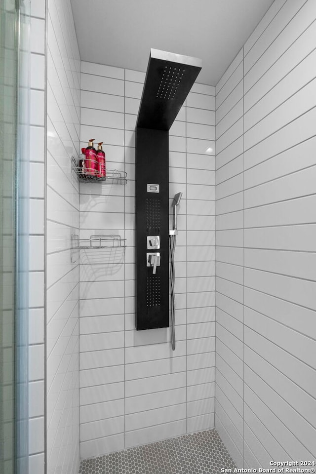 bathroom with tiled shower