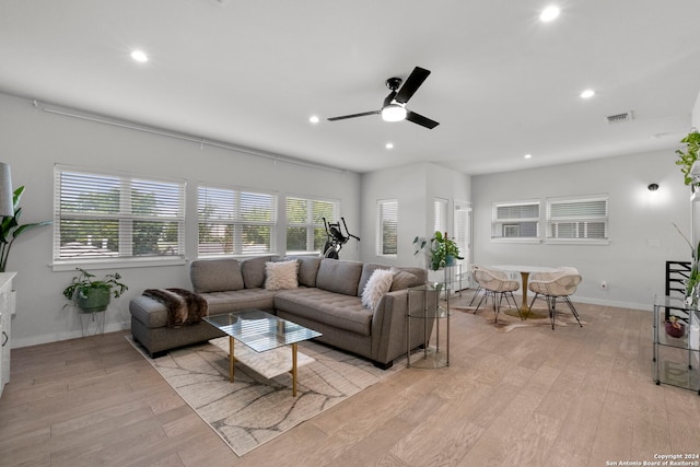 living room featuring light hardwood / wood-style floors and ceiling fan