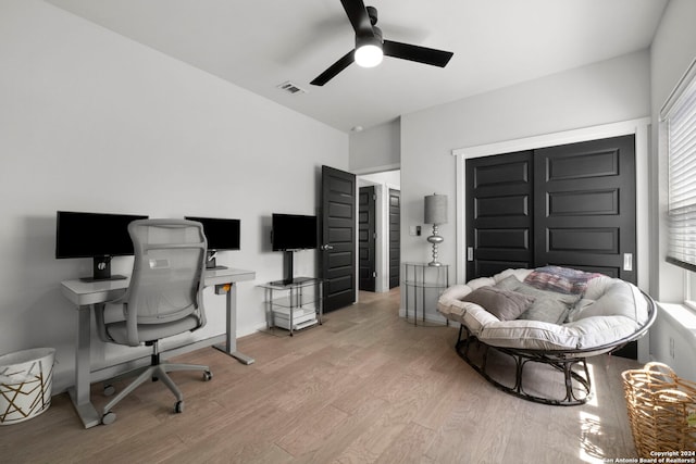 home office with ceiling fan and light hardwood / wood-style floors