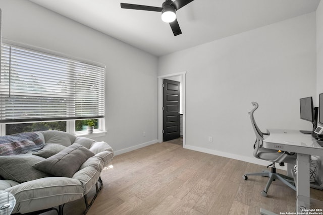 office area with light wood-type flooring and ceiling fan