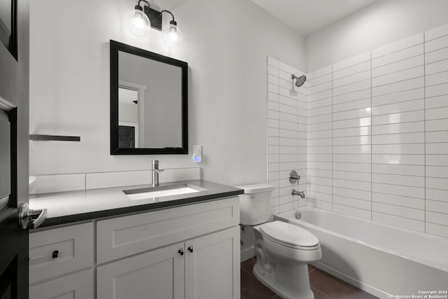 full bathroom with toilet, vanity, and tiled shower / bath