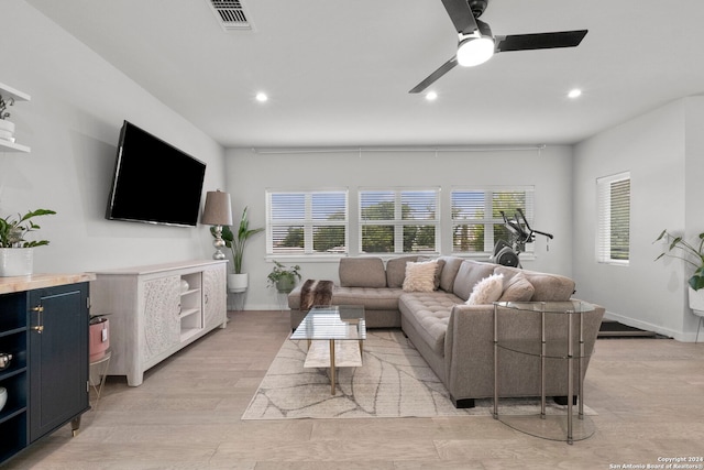 living room with ceiling fan and light hardwood / wood-style floors