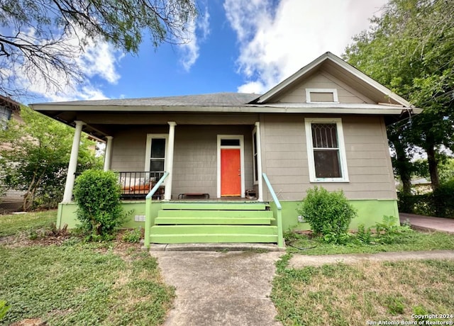 218 Coleman, San Antonio, TX 78208 - bungalow-style house featuring covered porch, roof with shingles, and a front yard
