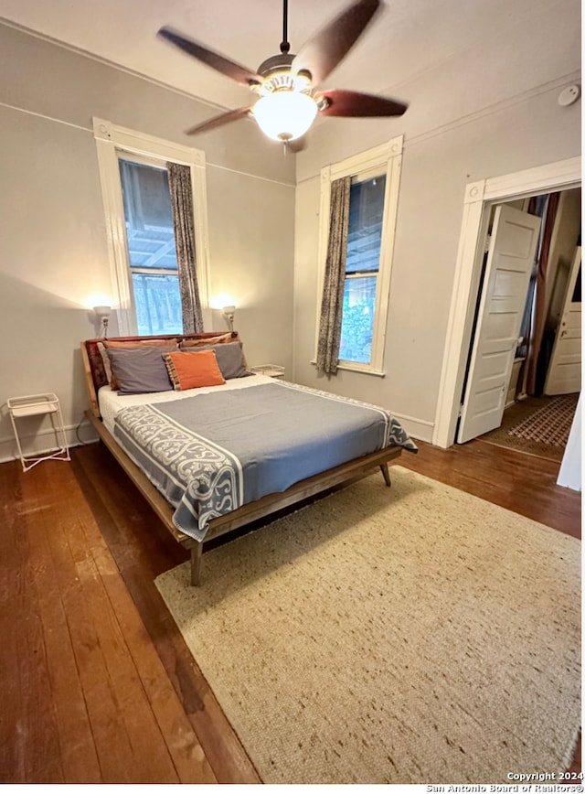 bedroom featuring dark hardwood / wood-style flooring and ceiling fan