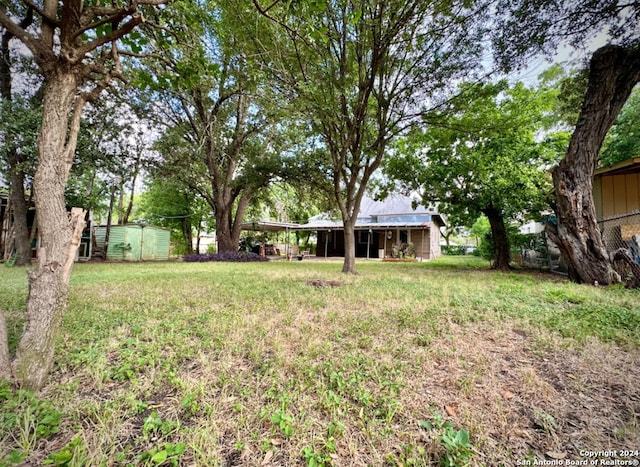 218 Coleman, San Antonio, TX 78208 - view of green lawn featuring an outbuilding and a carport