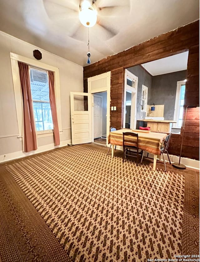 218 Coleman, San Antonio, TX 78208 - bedroom with multiple windows, baseboards, carpet floors, and wood walls