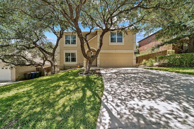 view of front of property featuring a garage and a front yard