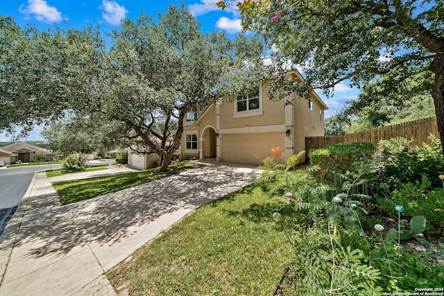 view of front facade featuring a garage, fence, concrete driveway, and stucco siding