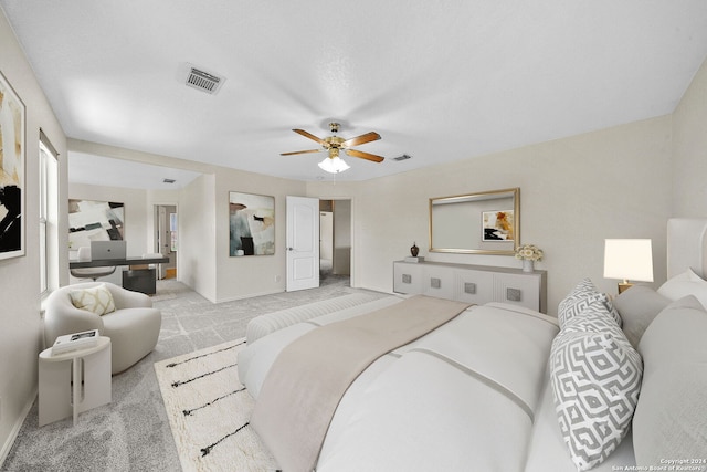 bedroom featuring light carpet, ceiling fan, visible vents, and baseboards