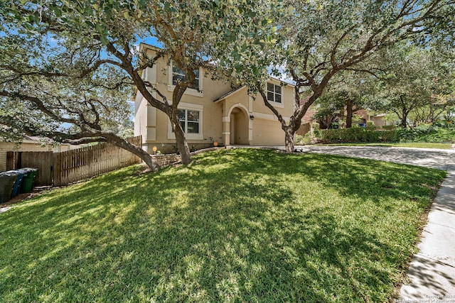 view of front facade with a garage and a front lawn