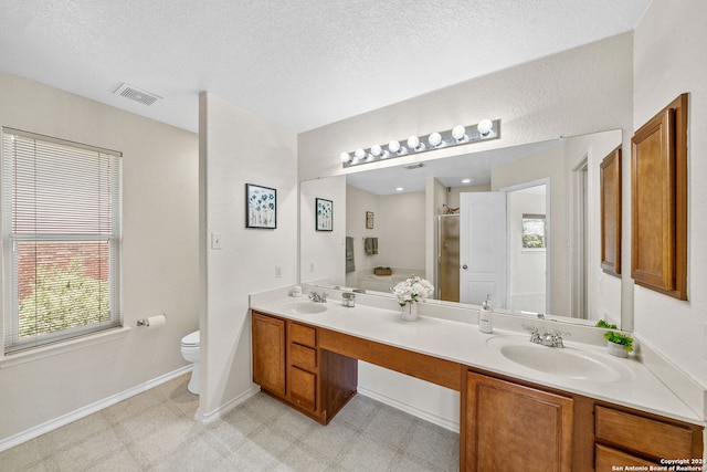 bathroom featuring a stall shower, visible vents, a sink, and tile patterned floors