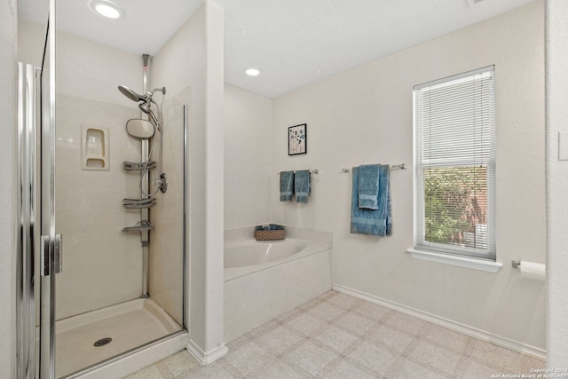 full bath featuring a stall shower, baseboards, tile patterned floors, a garden tub, and recessed lighting