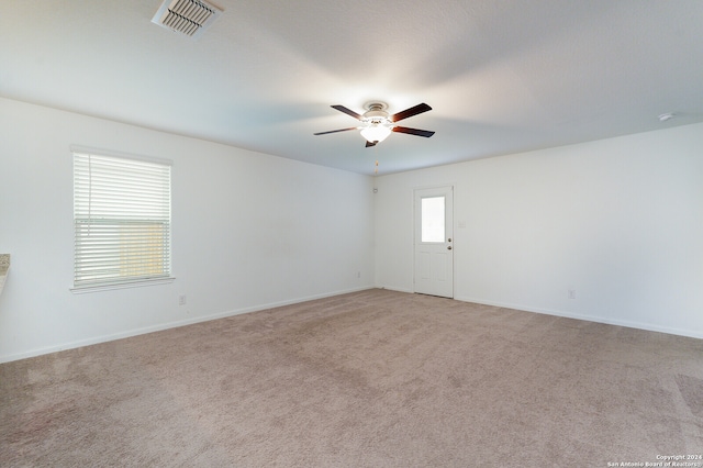 carpeted empty room featuring ceiling fan