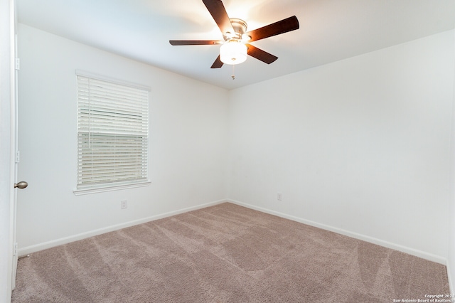 empty room featuring carpet flooring and ceiling fan