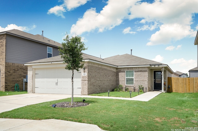 view of front of property with a garage and a front lawn