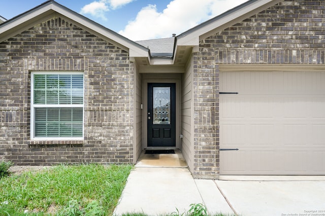 view of exterior entry with a garage