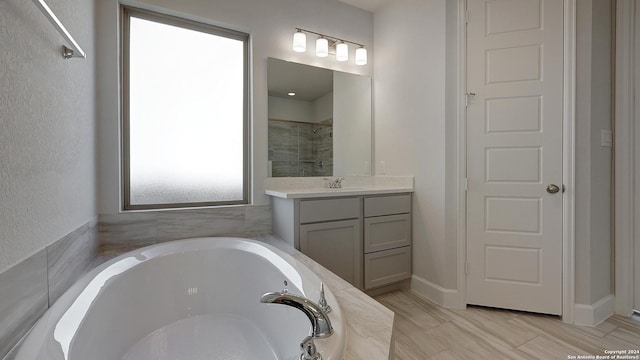 bathroom featuring independent shower and bath and vanity