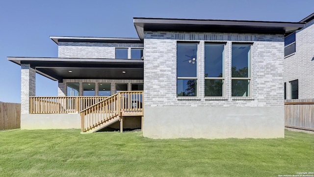 rear view of house featuring a yard