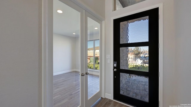 entryway featuring hardwood / wood-style flooring and french doors