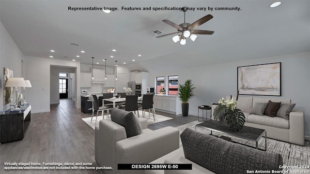 living room featuring ceiling fan and hardwood / wood-style flooring