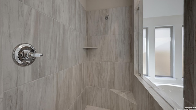 bathroom with a tile shower