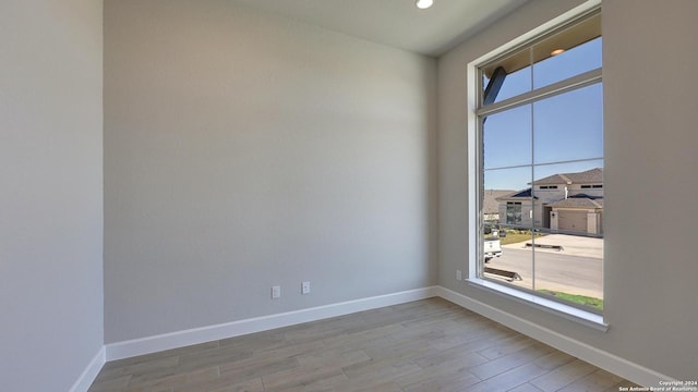 unfurnished room with hardwood / wood-style floors