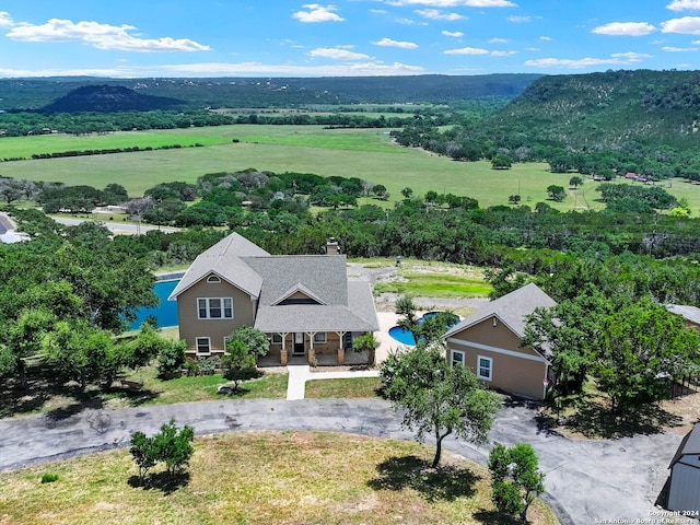 birds eye view of property featuring a mountain view and a rural view