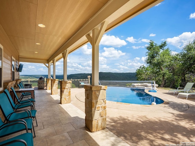 view of swimming pool featuring a patio area