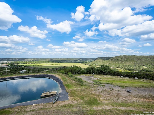 view of pool with a water view and a rural view