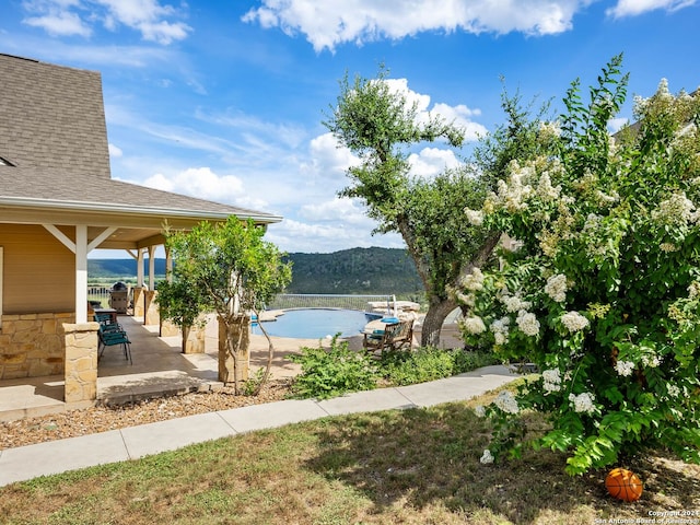 exterior space with a mountain view and a patio