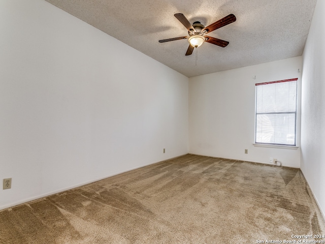 empty room with carpet floors, a textured ceiling, and ceiling fan