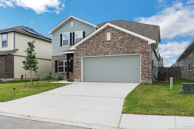 view of front facade with a garage, solar panels, and a front yard