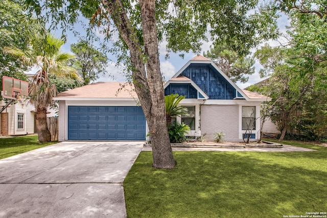 view of front of property featuring a garage and a front lawn