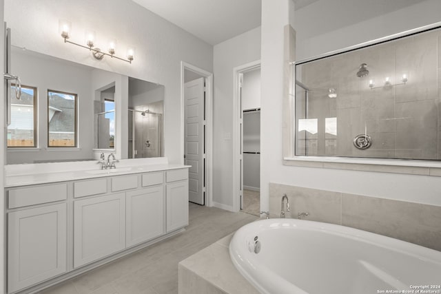 bathroom featuring separate shower and tub and vanity