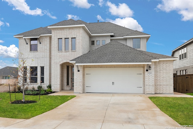 view of front facade featuring a front lawn and a garage