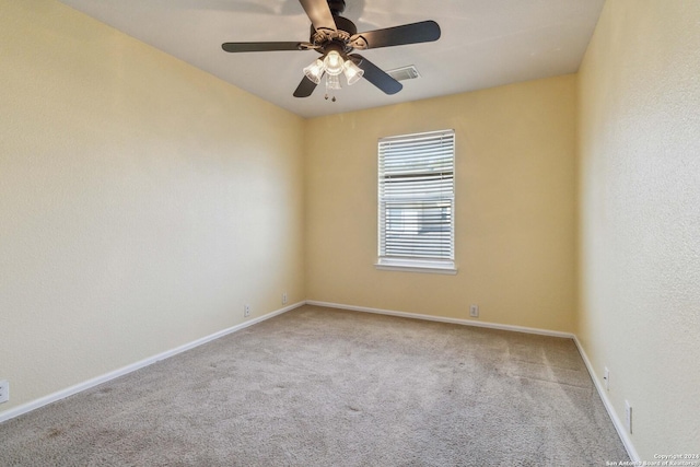 carpeted spare room featuring ceiling fan