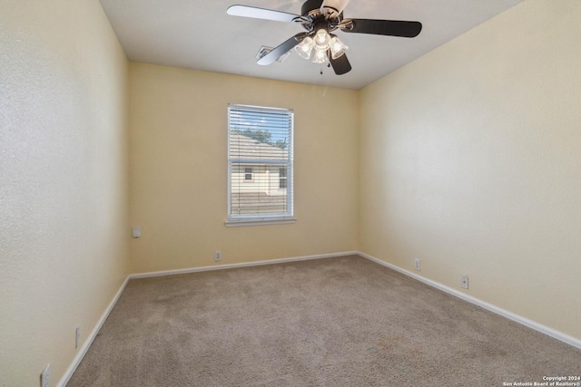 spare room featuring light carpet and ceiling fan