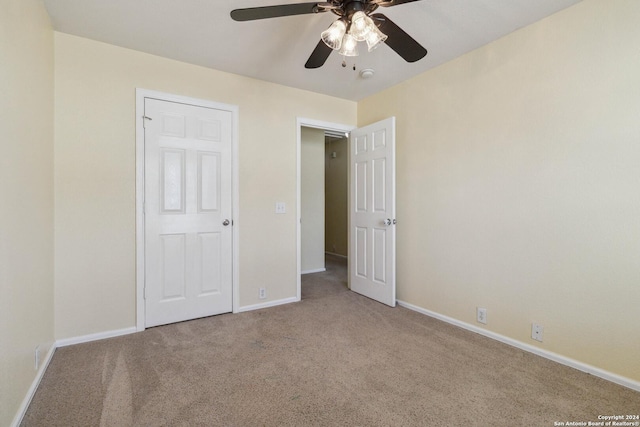 unfurnished bedroom with light carpet and ceiling fan