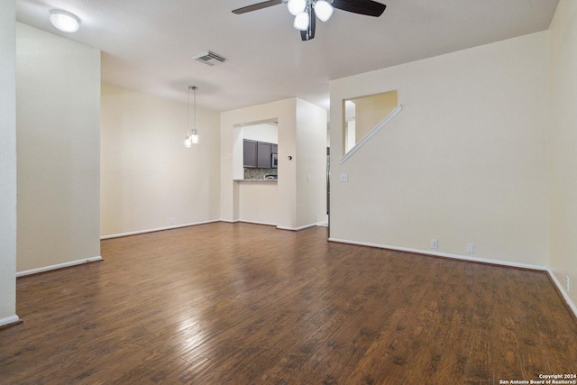 spare room featuring ceiling fan and dark hardwood / wood-style flooring